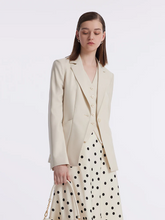 a lady in a beige wool one button blazer